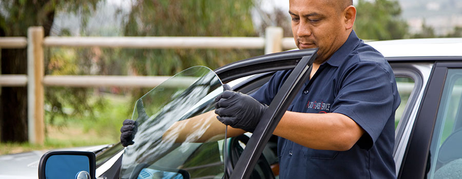 Silver Auto Glass Repair technician repairing a windshield